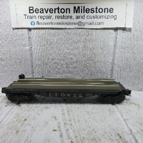 LIONEL FLATCAR WITH WHEEL LOAD, 56-57 VARIATION (A) BLACK FRAME, 56-57