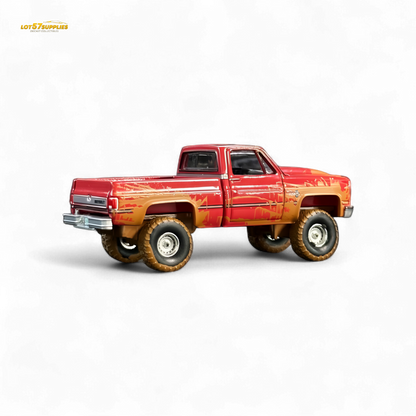 Auto World 1983 Chevrolet Silverado K10 4x4 Muddy Lifted 1:64